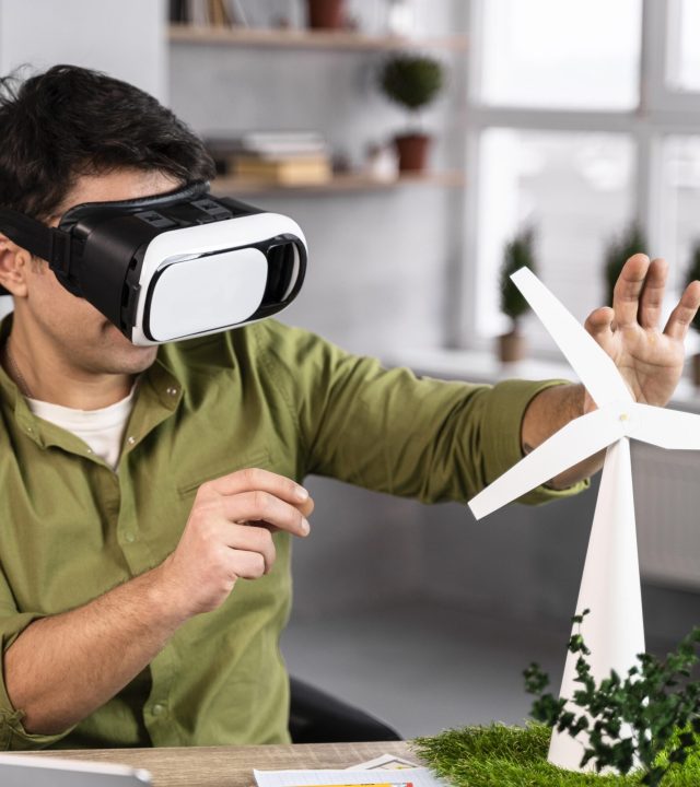 man working eco friendly wind power project with virtual reality headset